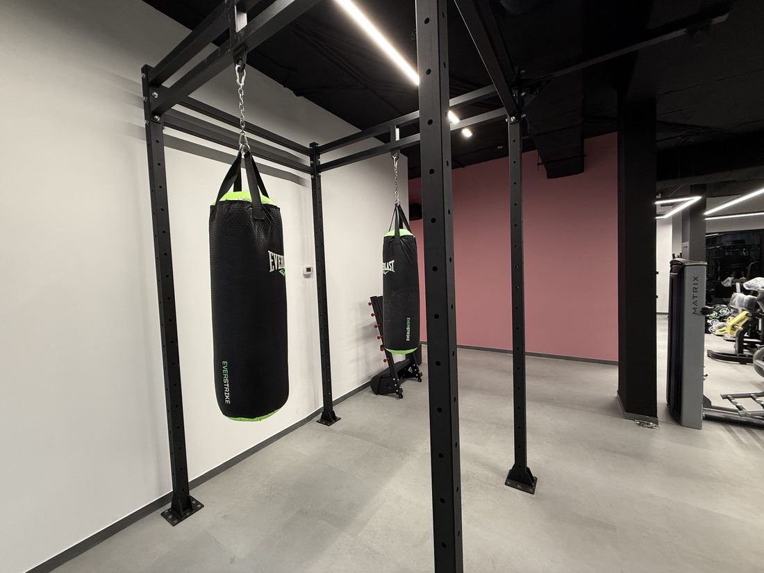 Two punching bags hanging from a rig