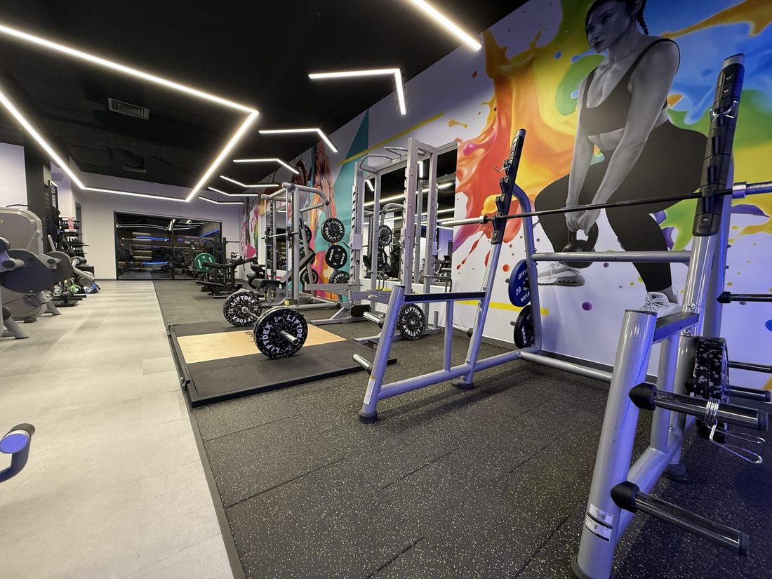 Free weight area with squat racks and a lifting platform